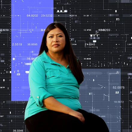 A woman sitting in front of data