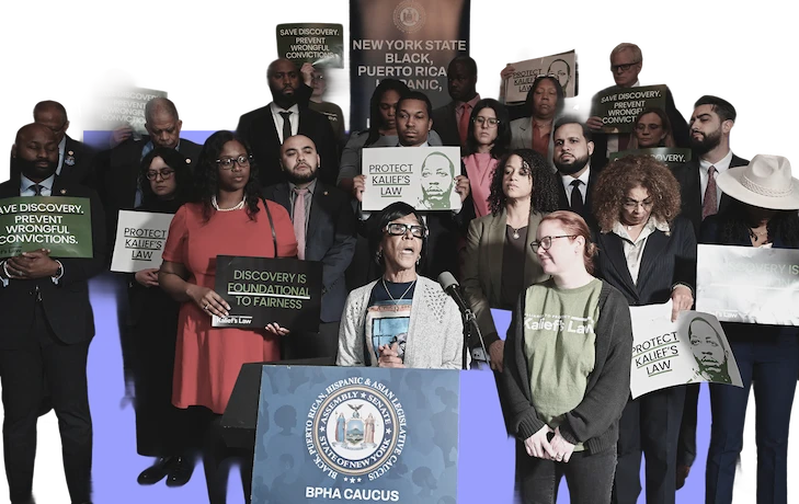 People standing behind podium giving a speech